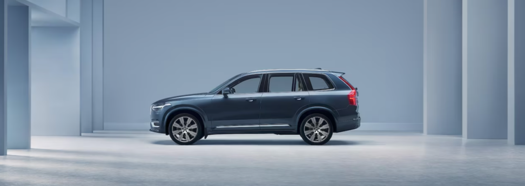 Volvo XC90 family car is parked in a spacious cool indoor room.